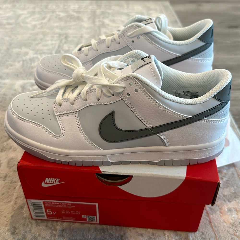 Brand new Nike Dunks kids size 5. Grey and white